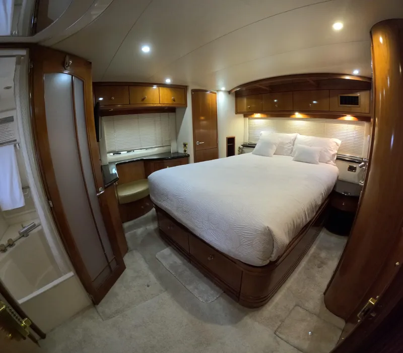 Slide: The Image of Luxurious bedroom interior of 2001 Carver 506 Motor Yacht with wood finishes and cozy lighting. - 37