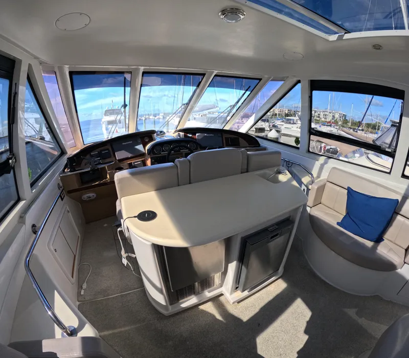 Slide: The Image of Interior of 2001 Carver 506 Motor Yacht with helm, seating, and windows. - 5