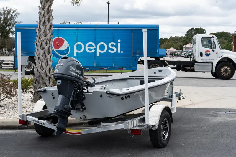 The Image of 2024 Mi Tide V1503 boat on trailer, parked near Pepsi truck. - 0