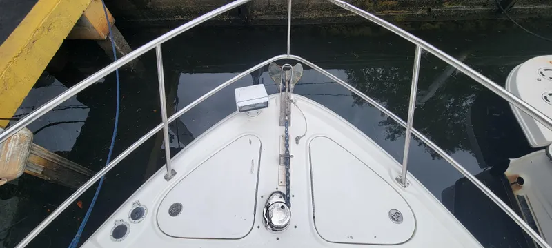 Slide: The Image of Bow of 2004 Sea Ray 455 Sundancer yacht docked at marina. - 10