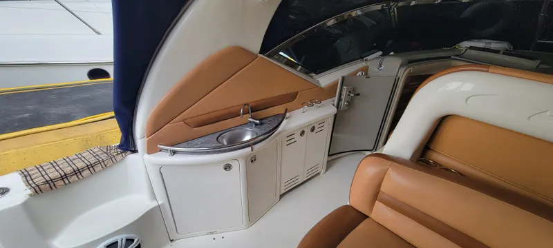 Slide: The Image of 2004 Sea Ray 455 Sundancer interior with sink and seating area. - 11