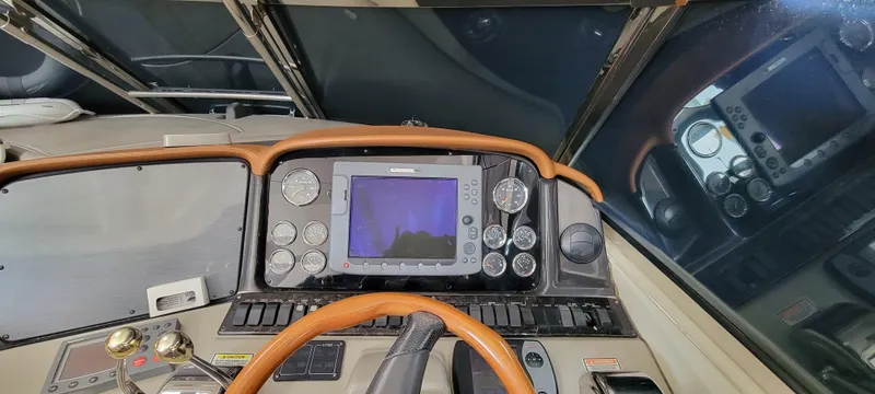 Slide: The Image of Control panel of a 2004 Sea Ray 455 Sundancer yacht with navigation instruments. - 14