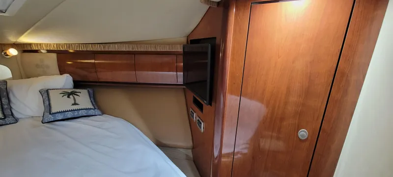 Slide: The Image of Luxurious cabin interior of 2004 Sea Ray 455 Sundancer yacht with wood paneling and TV. - 22