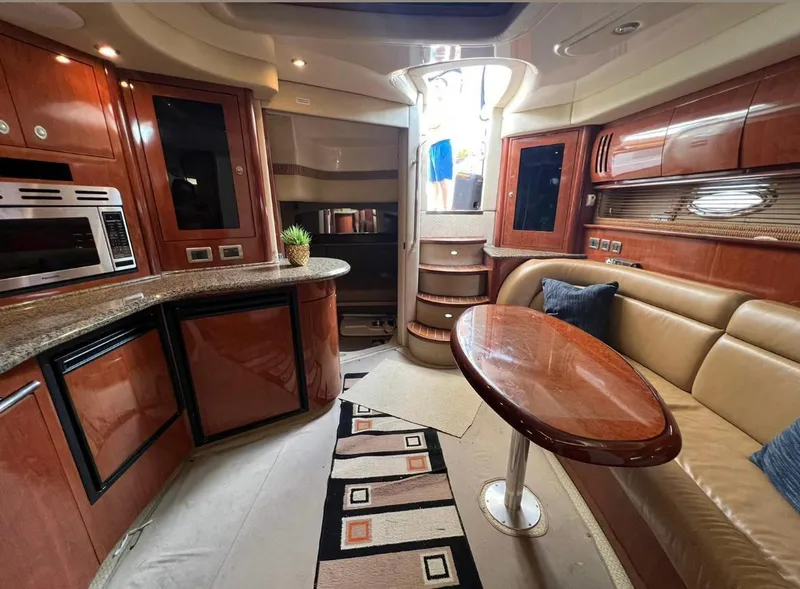 Slide: The Image of Luxurious interior of 2004 Sea Ray 455 Sundancer yacht with modern kitchen and seating area. - 26