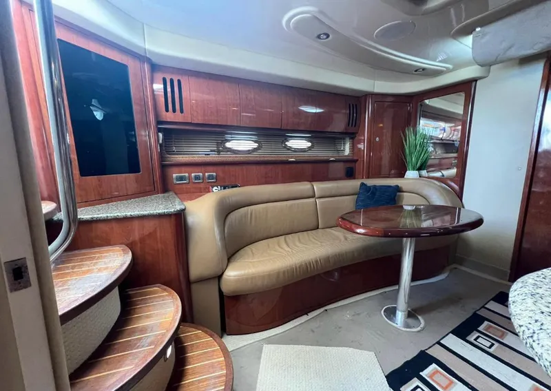 Slide: The Image of Luxurious interior of a 2004 Sea Ray 455 Sundancer yacht with leather seating and wooden finishes. - 27