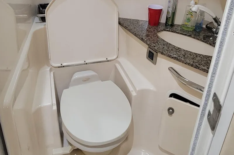 Slide: The Image of 2004 Sea Ray 455 Sundancer bathroom with toilet and granite countertop. - 31