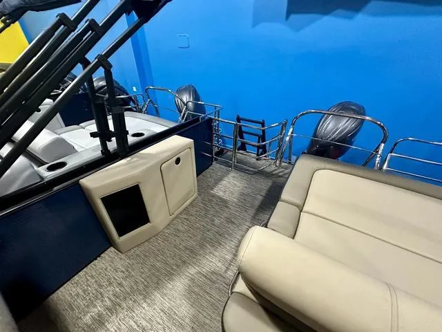 Slide: The Image of 2024 Godfrey Sweetwater 2286 SFL GTP pontoon boat interior with seating and dual outboard motors. - 11