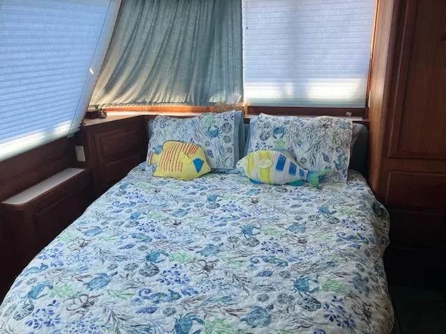 Slide: The Image of Cozy bedroom in 1989 Bluewater Yachts 55' Coastal Cruiser with fish-themed decor. - 11