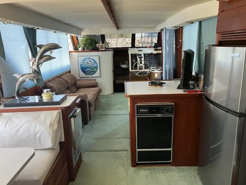 Slide: The Image of Interior of 1989 Bluewater Yachts 55' Coastal Cruiser with modern kitchen and cozy seating area. - 12