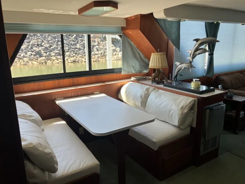 Slide: The Image of Interior of 1989 Bluewater Yachts 55' Coastal Cruiser with dining area and large windows. - 13