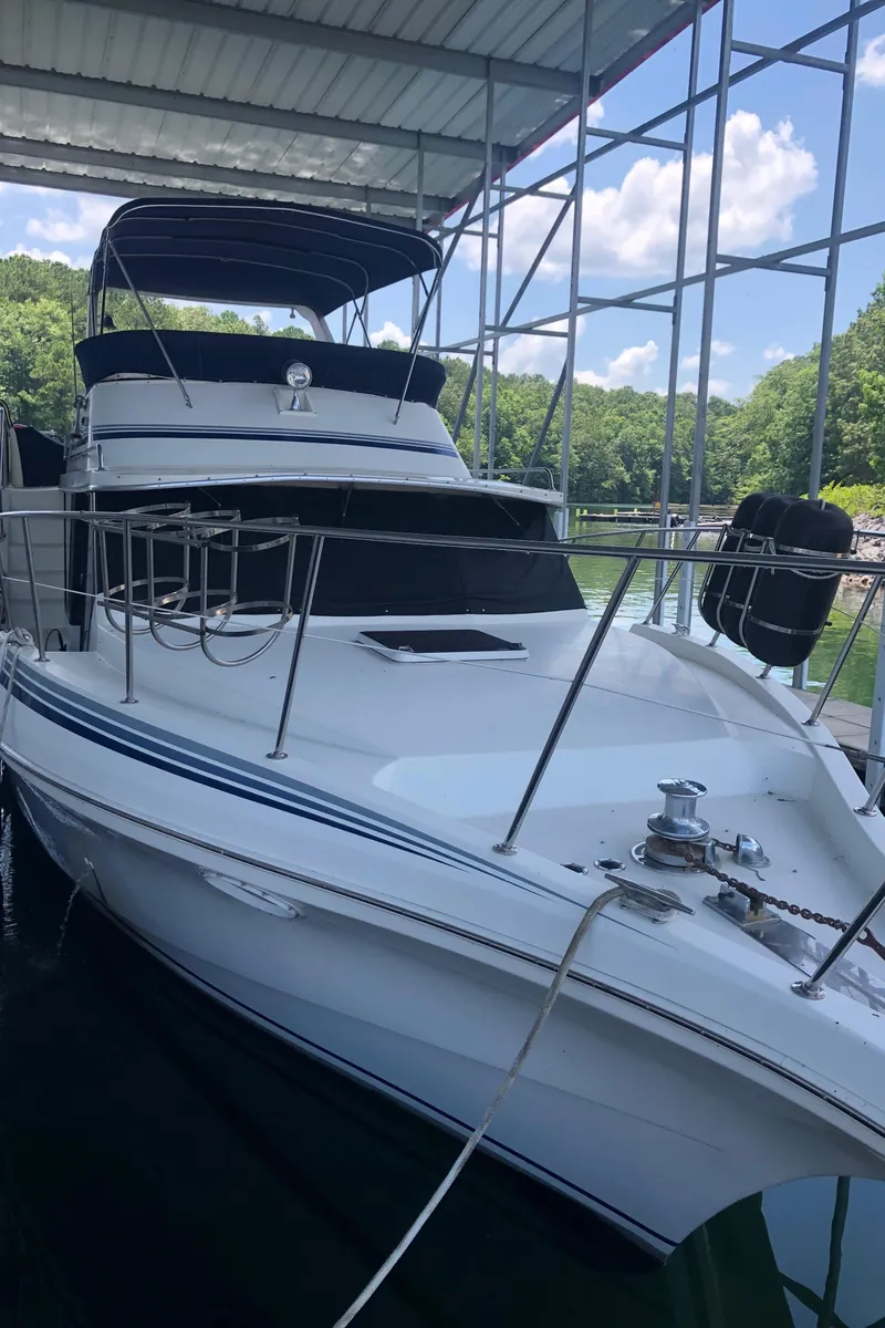 Slide: The Image of 1989 Bluewater Yachts 55' Coastal Cruiser docked under a canopy. - 17