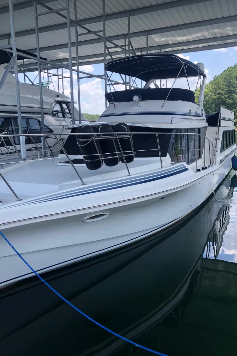 Slide: The Image of 1989 Bluewater Yachts 55' Coastal Cruiser docked under a covered marina. - 18