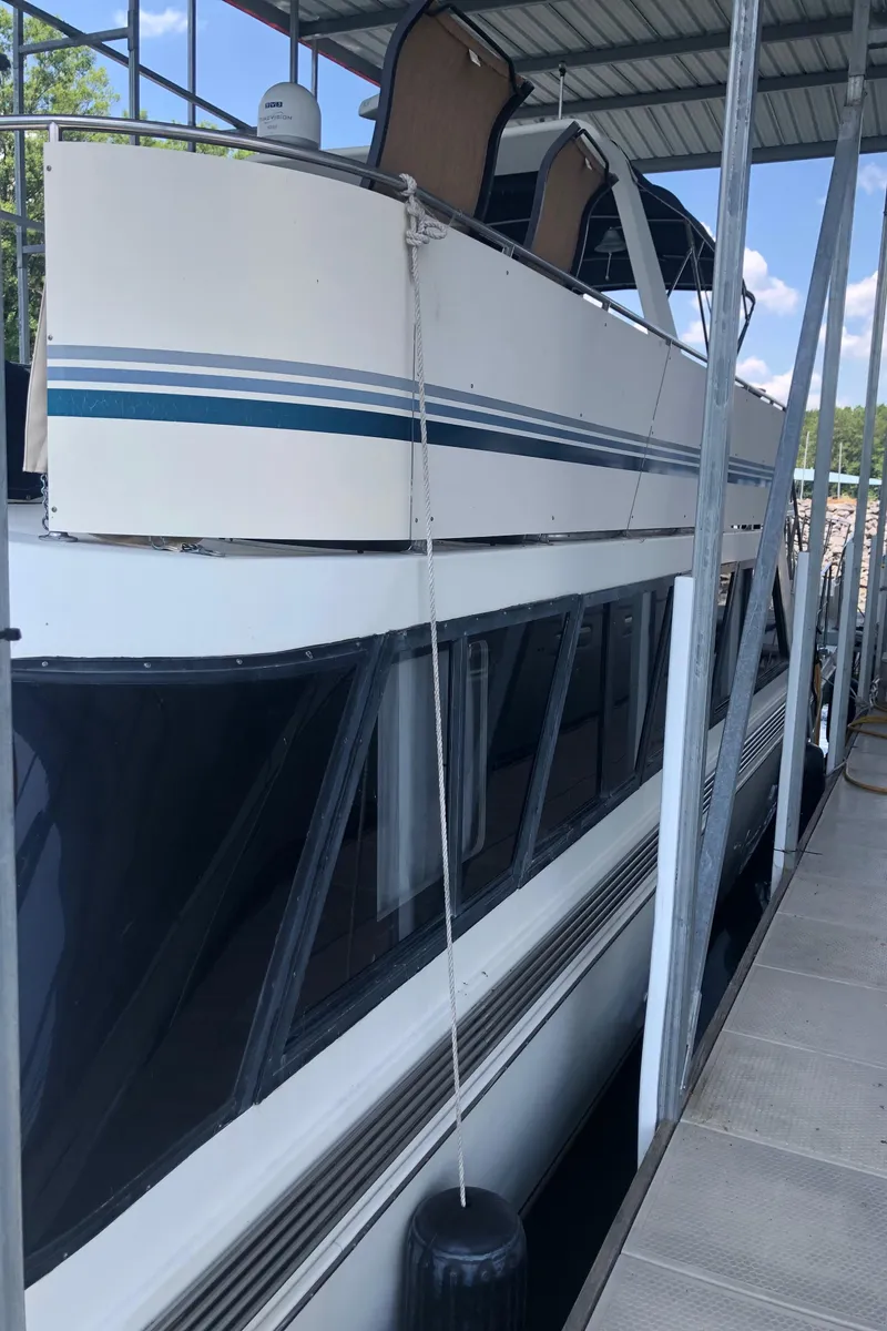 Slide: The Image of 1989 Bluewater Yachts 55' Coastal Cruiser docked under a covered slip. - 22