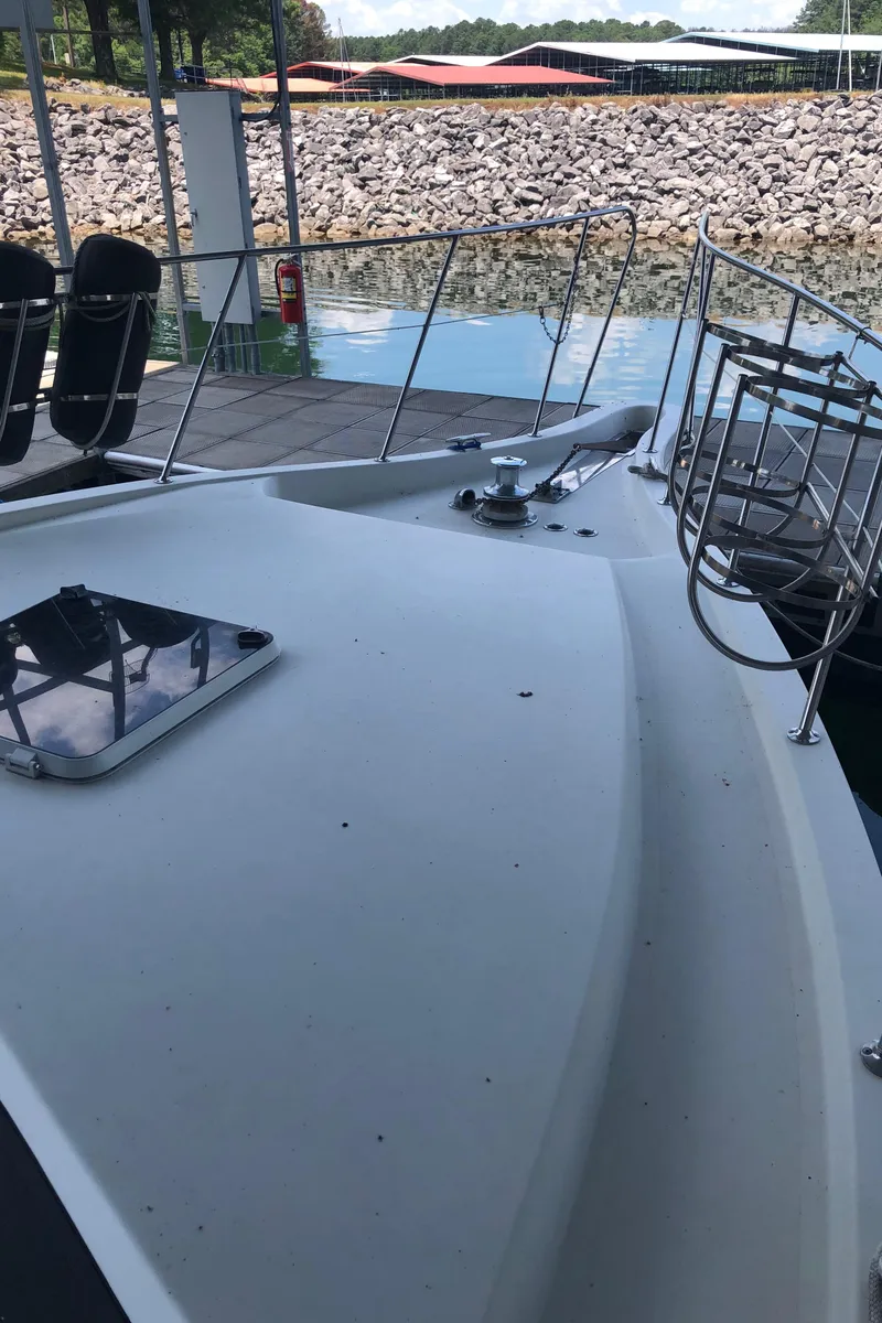 Slide: The Image of 1989 Bluewater Yachts 55' Coastal Cruiser docked, showing bow and deck details. - 23