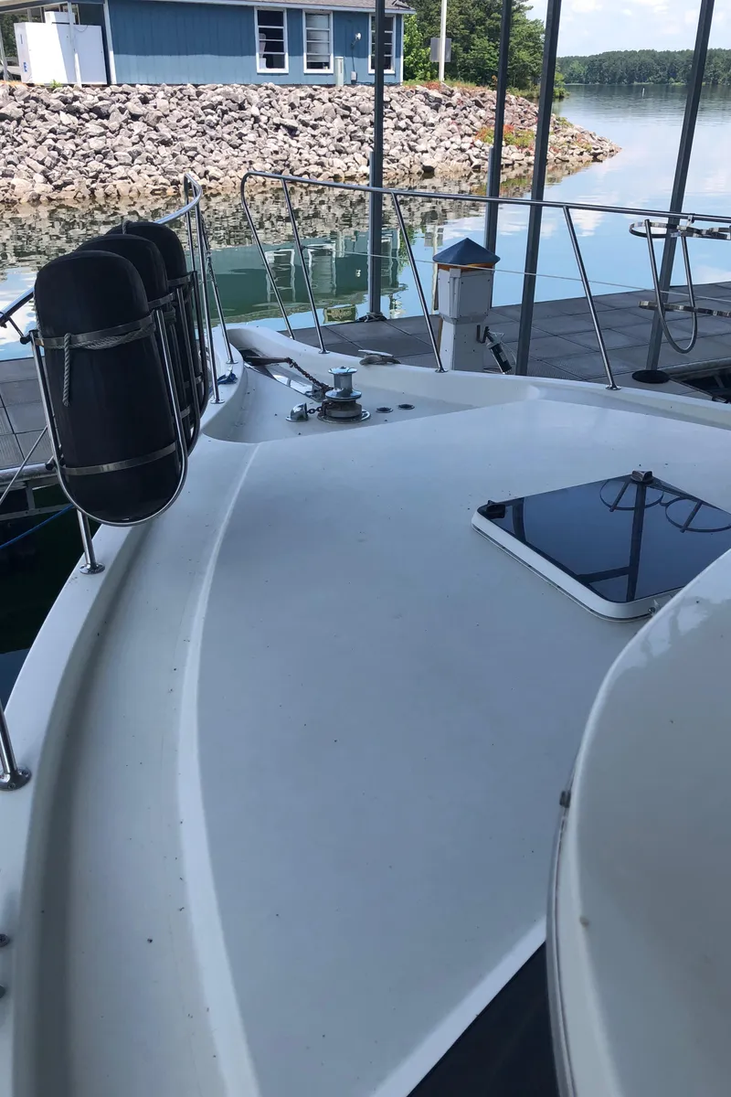 Slide: The Image of 1989 Bluewater Yachts 55' Coastal Cruiser docked at a marina. - 24