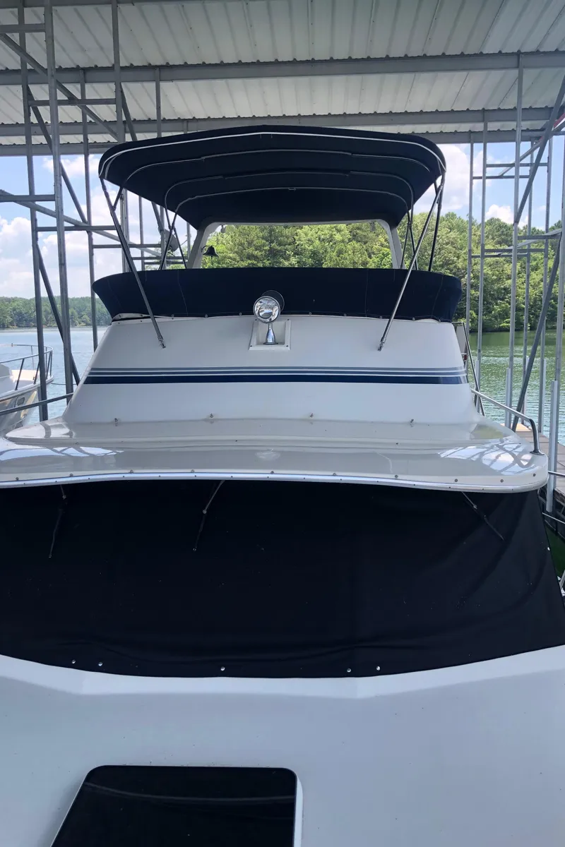 Slide: The Image of 1989 Bluewater Yachts 55' Coastal Cruiser docked under a covered marina. - 26