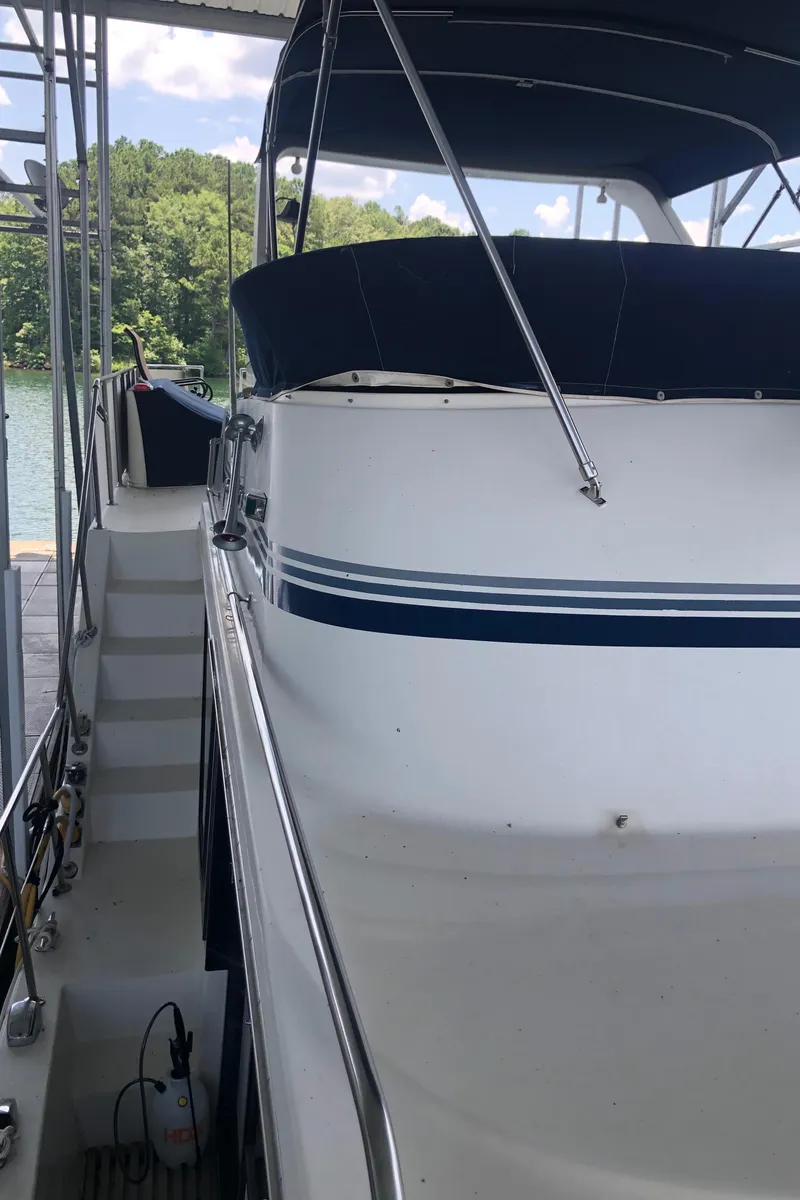 Slide: The Image of 1989 Bluewater Yachts 55' Coastal Cruiser docked, side view with canopy. - 28
