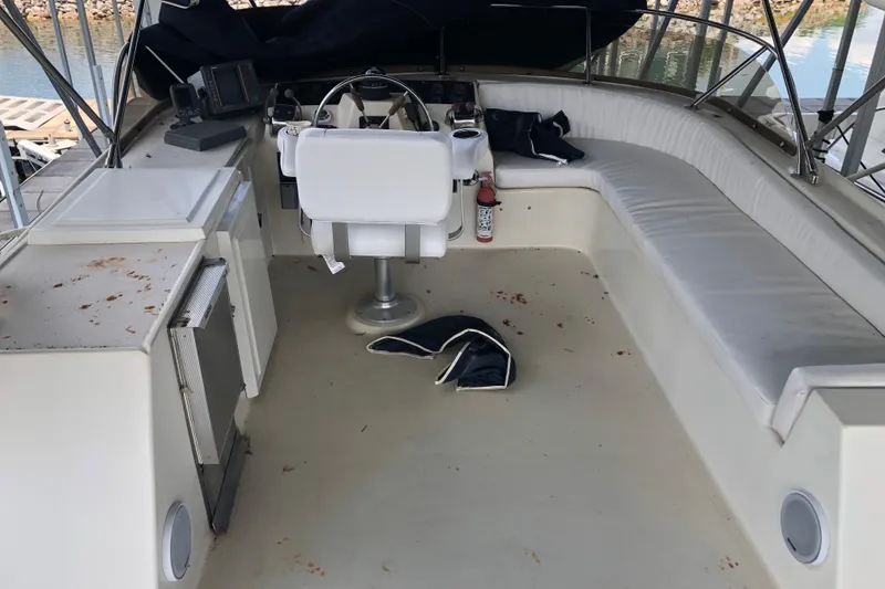 Slide: The Image of 1989 Bluewater Yachts 55' Coastal Cruiser helm station with seating and navigation equipment. - 32