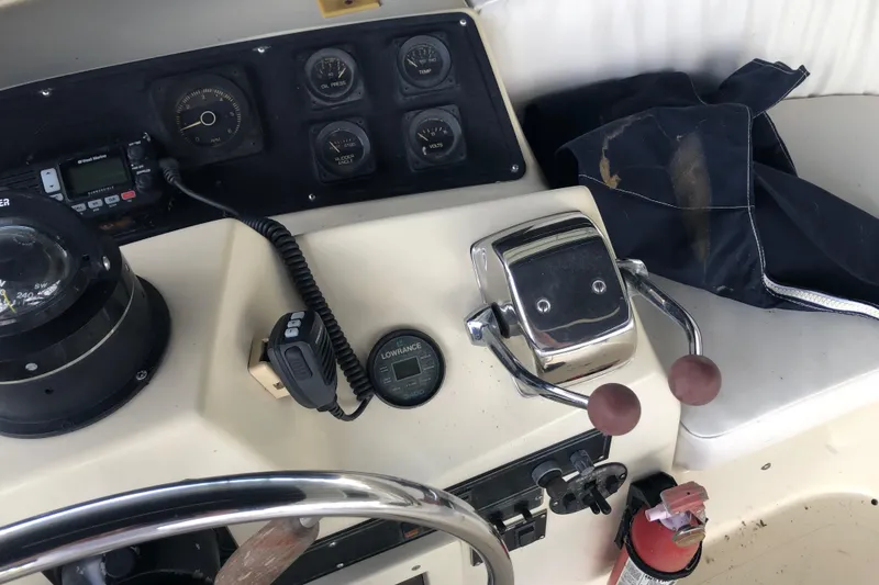 Slide: The Image of 1989 Bluewater Yachts 55' Coastal Cruiser helm with controls and navigation instruments. - 36