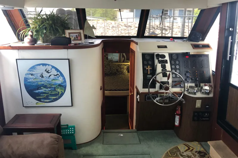 Slide: The Image of Interior helm of a 1989 Bluewater Yachts 55' Coastal Cruiser with steering wheel and control panel. - 40