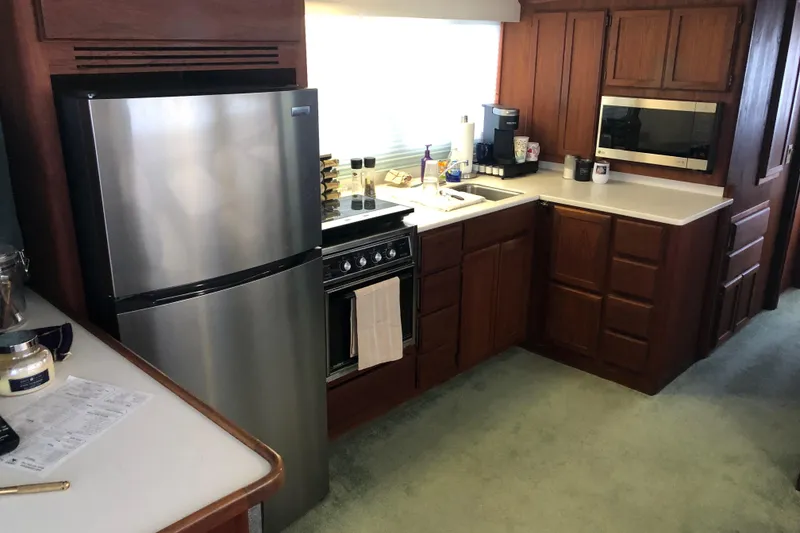 Slide: The Image of Modern kitchen in a 1989 Bluewater Yachts 55' Coastal Cruiser with stainless steel appliances. - 47