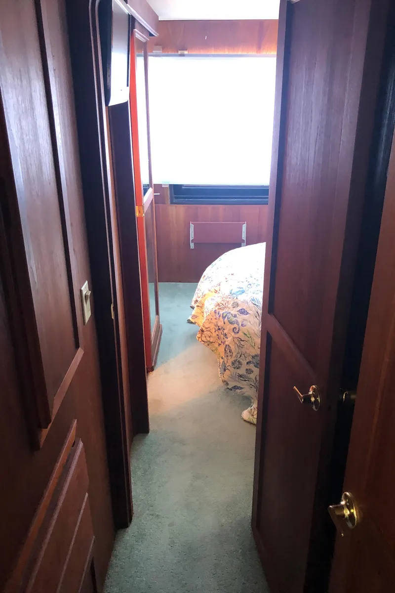 Slide: The Image of Interior hallway of 1989 Bluewater Yachts 55' Coastal Cruiser with bedroom view. - 49