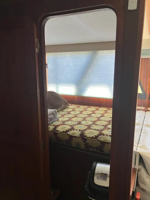 Slide: The Image of Interior bedroom of 1989 Bluewater Yachts 55' Coastal Cruiser with floral bedspread. - 9
