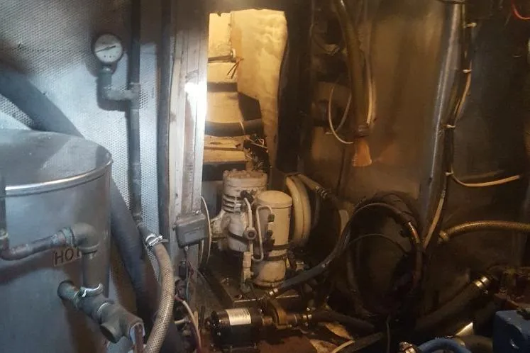 Slide: The Image of Engine room of 1973 Hodgdon DOLPHIN 47 yacht with visible machinery and pipes. - 12