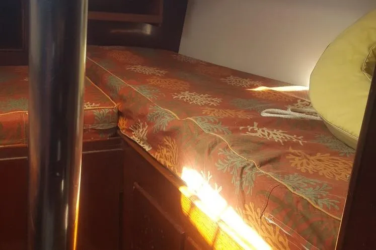 Slide: The Image of Interior cabin of 1973 Hodgdon DOLPHIN 47 with patterned cushions and wooden accents. - 16