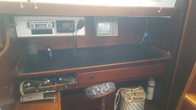 Slide: The Image of Navigation station of 1973 Hodgdon DOLPHIN 47 yacht with equipment and storage. - 2