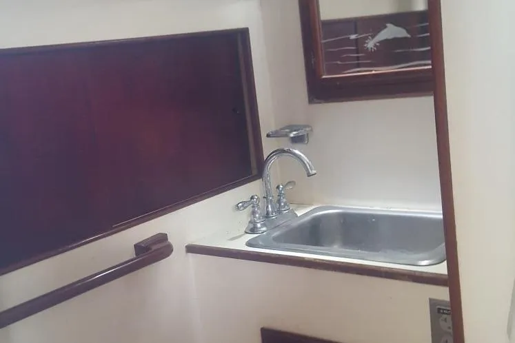Slide: The Image of Small sink area in 1973 Hodgdon DOLPHIN 47 boat with wooden accents. - 21