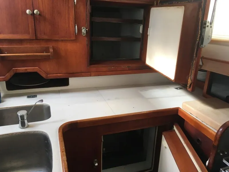 Slide: The Image of Interior of 1973 Hodgdon DOLPHIN 47 yacht kitchen with wooden cabinets and stainless steel sink. - 4