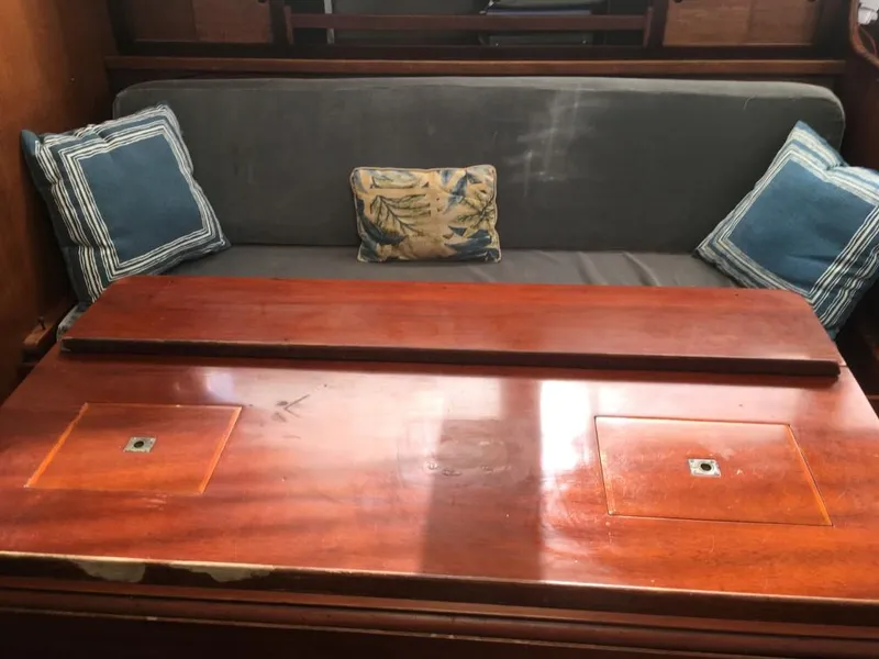 Slide: The Image of Interior of 1973 Hodgdon DOLPHIN 47 with wooden table and cushioned seating. - 5