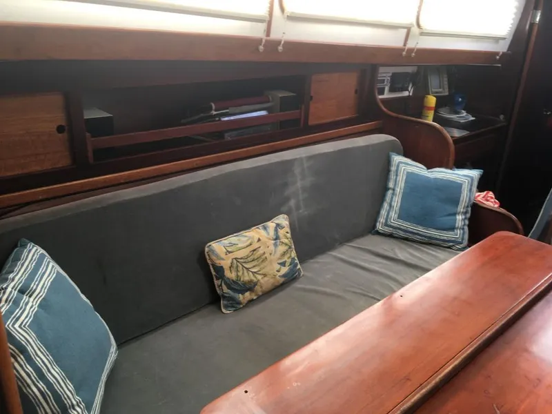 Slide: The Image of Interior of 1973 Hodgdon DOLPHIN 47 yacht with cushioned seating and wooden table. - 7