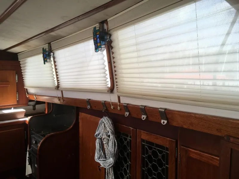 Slide: The Image of Interior of 1973 Hodgdon DOLPHIN 47 yacht with wooden cabinets and pleated window blinds. - 8