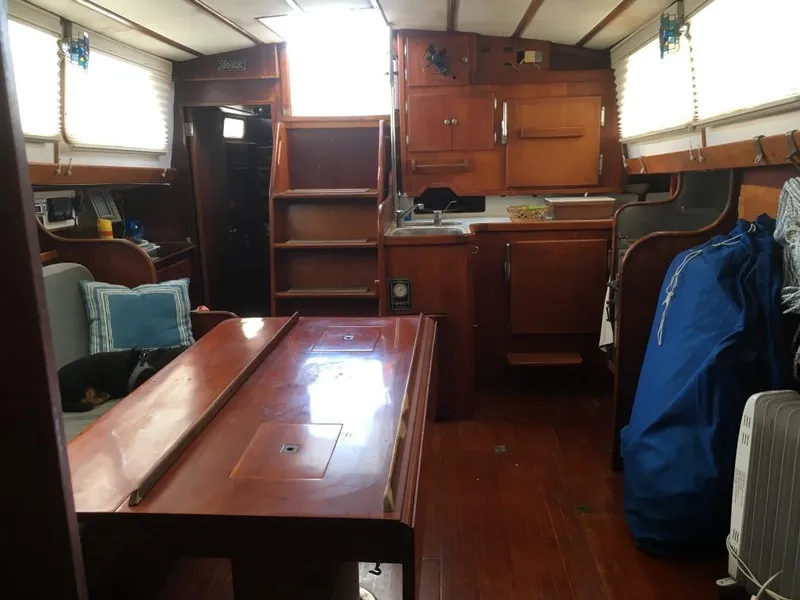 Slide: The Image of Interior of 1973 Hodgdon DOLPHIN 47 sailboat with wooden furnishings and cozy seating area. - 9
