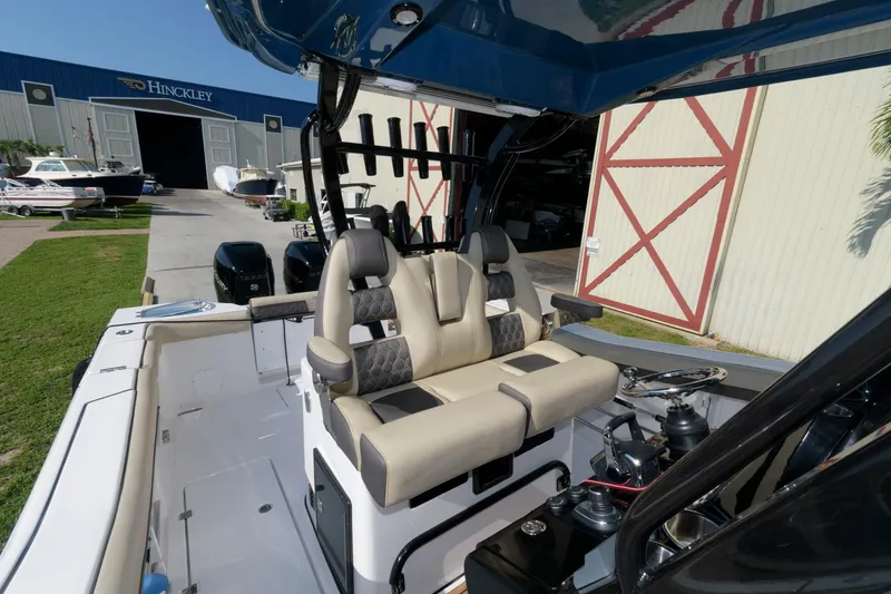 Slide: The Image of 2023 Tidewater 320 CC Adventure boat interior with dual seats and control panel. - 17