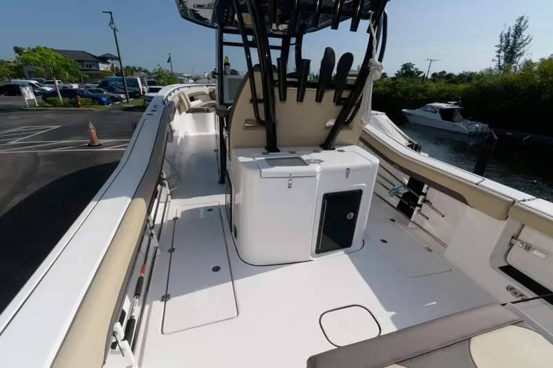 Slide: The Image of 2023 Tidewater 320 CC Adventure boat interior with seating and storage. - 19