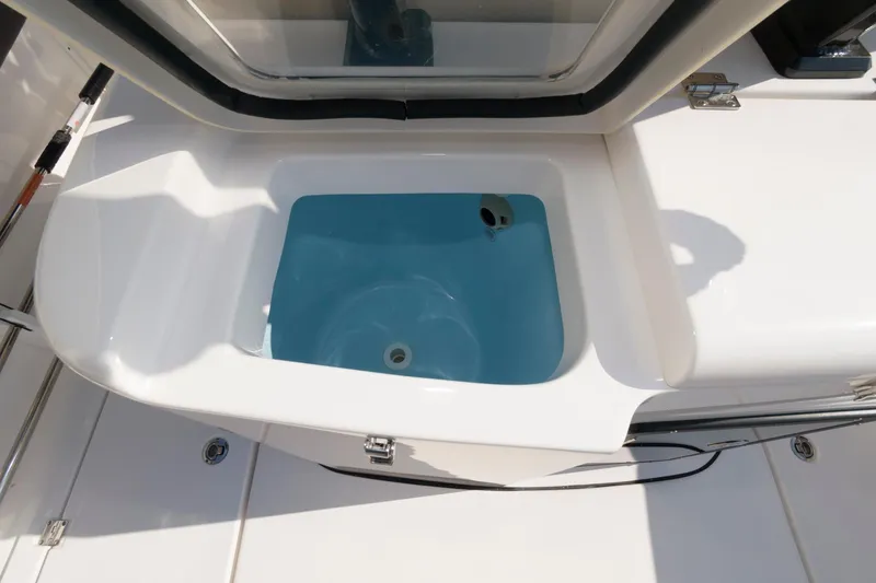 Slide: The Image of 2023 Tidewater 320 CC Adventure livewell with open lid. - 22