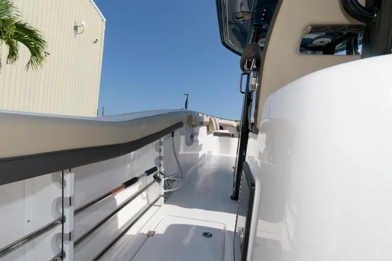 Slide: The Image of 2023 Tidewater 320 CC Adventure boat deck with fishing rod holders. - 24