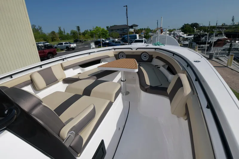 Slide: The Image of 2023 Tidewater 320 CC Adventure boat with spacious seating and a central table. - 5