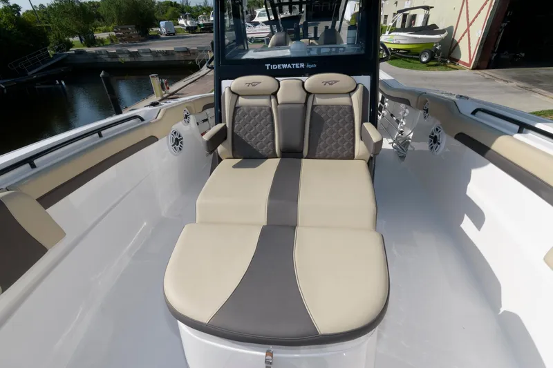 Slide: The Image of 2023 Tidewater 320 CC Adventure boat with cushioned seating area. - 7