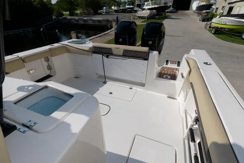 Slide: The Image of 2023 Tidewater 320 CC Adventure boat deck with twin outboard motors. - 9
