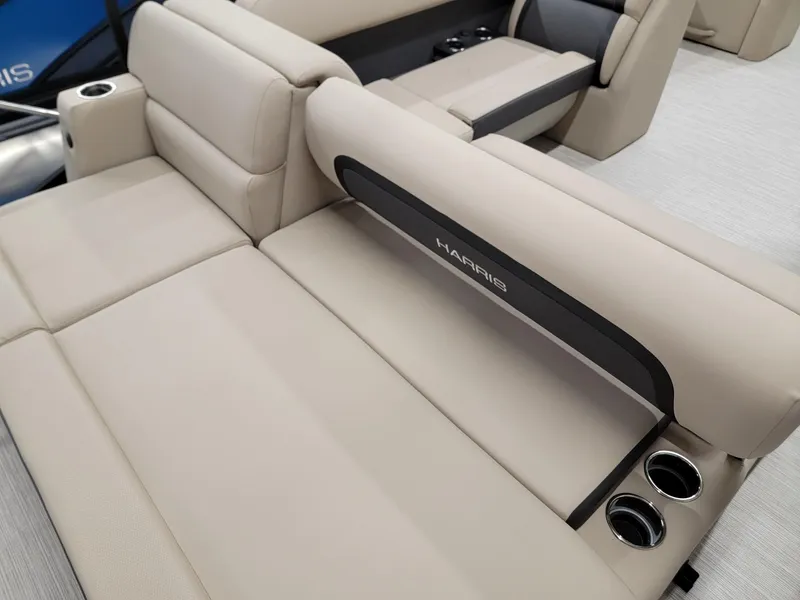 Slide: The Image of 2024 Harris Cruiser 250 boat interior with beige seating and cup holders. - 17
