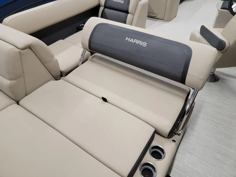 Slide: The Image of 2024 Harris Cruiser 250 boat interior with beige seating and cup holders. - 18