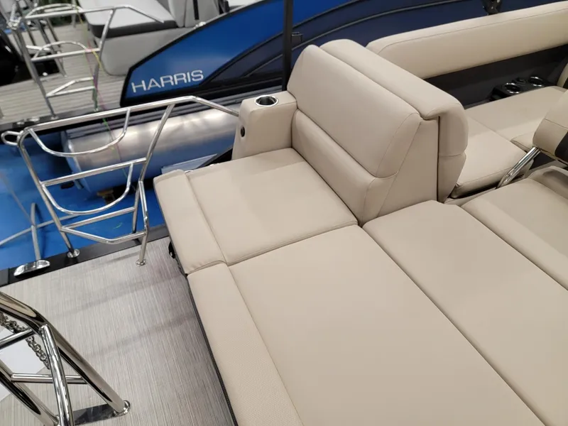 Slide: The Image of 2024 Harris Cruiser 250 boat with beige seating and blue exterior. - 19