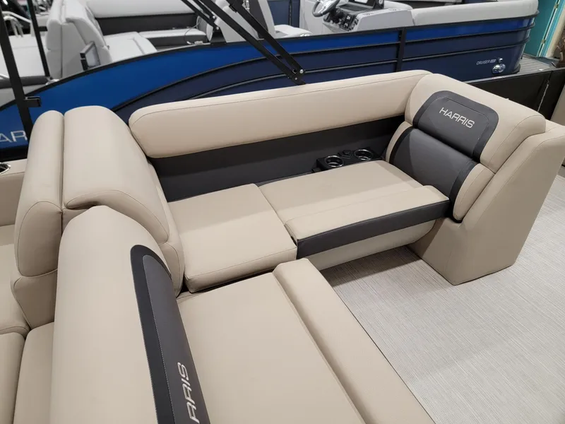 Slide: The Image of 2024 Harris Cruiser 250 boat interior with beige and gray seating. - 21