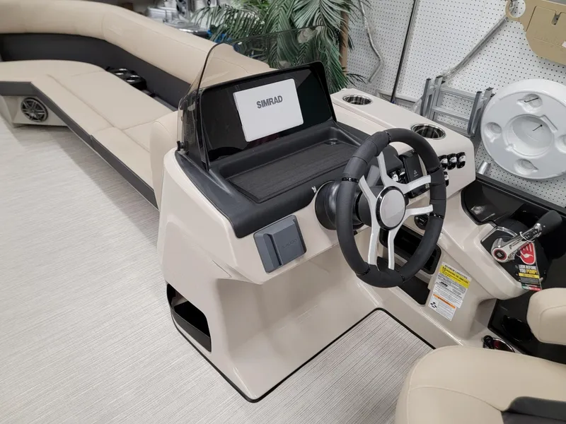 Slide: The Image of 2024 Harris Cruiser 250 boat interior with steering console and seating. - 23