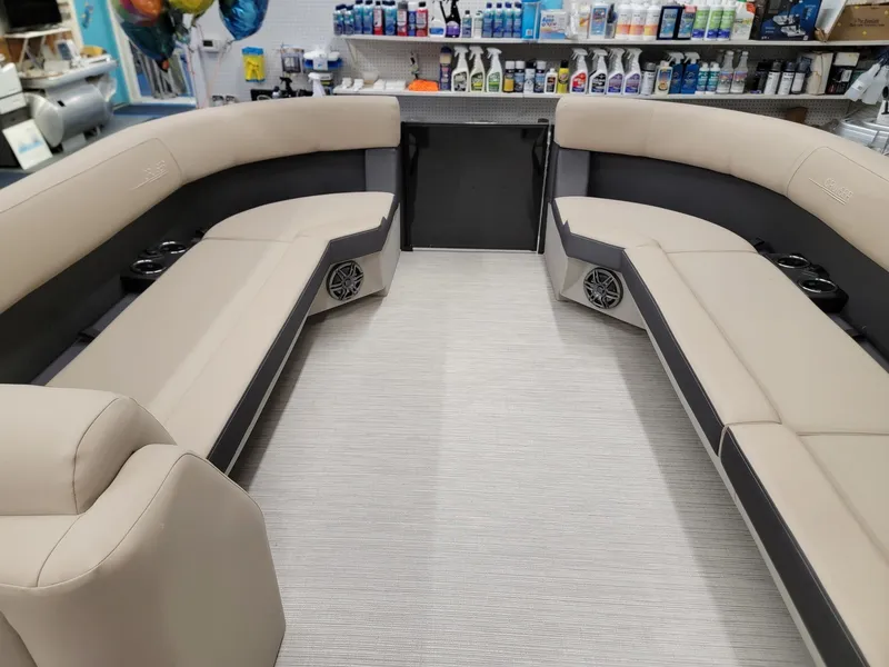Slide: The Image of 2024 Harris Cruiser 250 boat interior with beige seating and modern amenities. - 25
