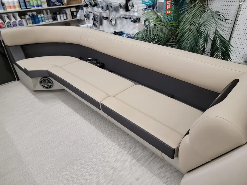 Slide: The Image of 2024 Harris Cruiser 250 boat interior with beige and black seating. - 26